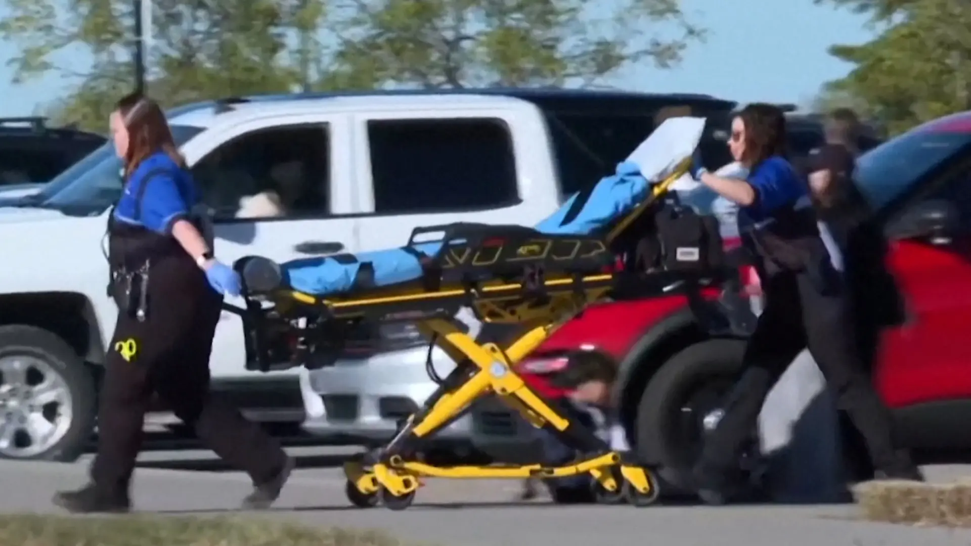 A stretcher is brought to the scene where a vehicle drove through a soccer game at the Stryker Sports Complex in Wichita