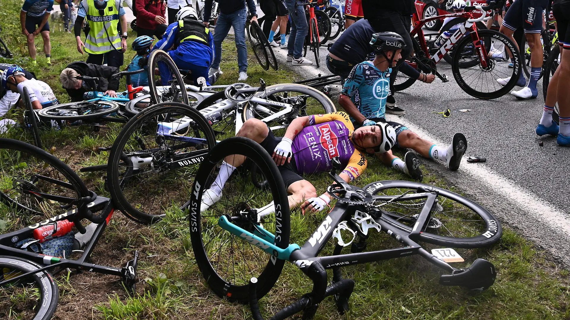 26.06.2021, Frankreich, Landerneau: Radsport: UCI WorldTour - Tour de France, Brest - Landerneau (197,80 km), 1. Etappe. Ein Fahrer von Alpecin-Fenix (l) und Bryan Coquard (r) aus Frankreich von BB Hotels P/B KTM liegen nach einem Sturz auf dem Boden. Foto: Pool Anne-Christine Poujoulat/BELGA/dpa +++ dpa-Bildfunk +++