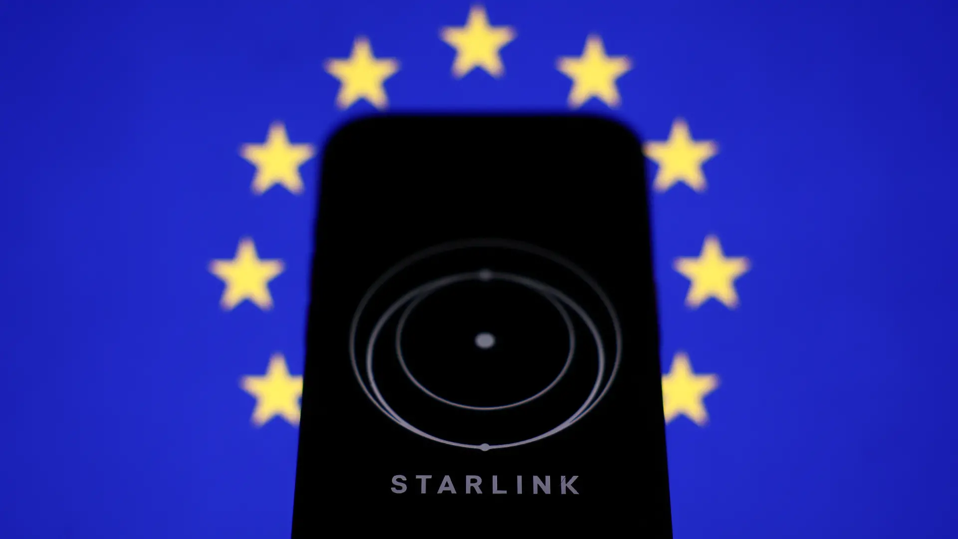 European Union flag displayed on a laptop screen and Starlink logo displayed on a phone screen are seen in this illustration photo taken in Krakow, Poland on March 11, 2025. (Photo by Jakub Porzycki/NurPhoto)