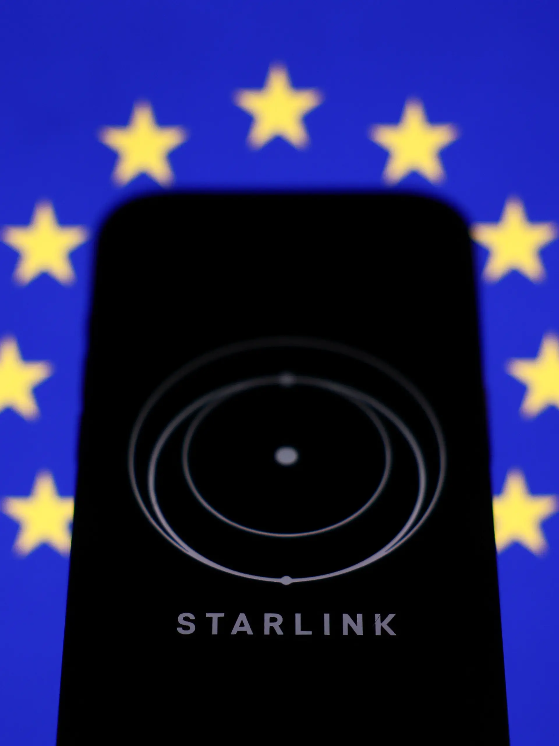 European Union flag displayed on a laptop screen and Starlink logo displayed on a phone screen are seen in this illustration photo taken in Krakow, Poland on March 11, 2025. (Photo by Jakub Porzycki/NurPhoto)