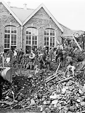 Rettungskräfte suchen am 21. Oktober 1966 in den Trümmern der zerstörten Pantglas-Grundschule in Aberfan nach Verschütteten.