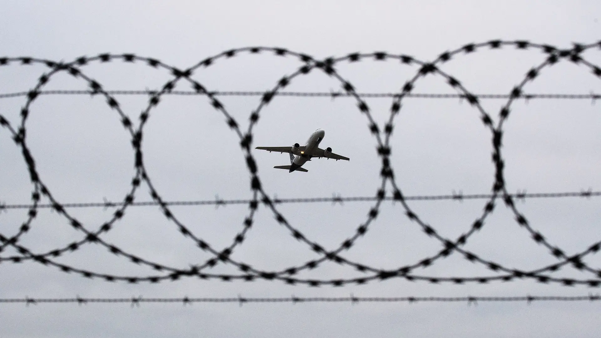ARCHIV - 06.01.2020, Niedersachsen, Hannover: Ein Flugzeug startet - fotografiert durch Stacheldraht am Flughafenzaun. (zu dpa: «EU schafft Basis für Abschiebezentren außerhalb Europas») Foto: Julian Stratenschulte/dpa +++ dpa-Bildfunk +++