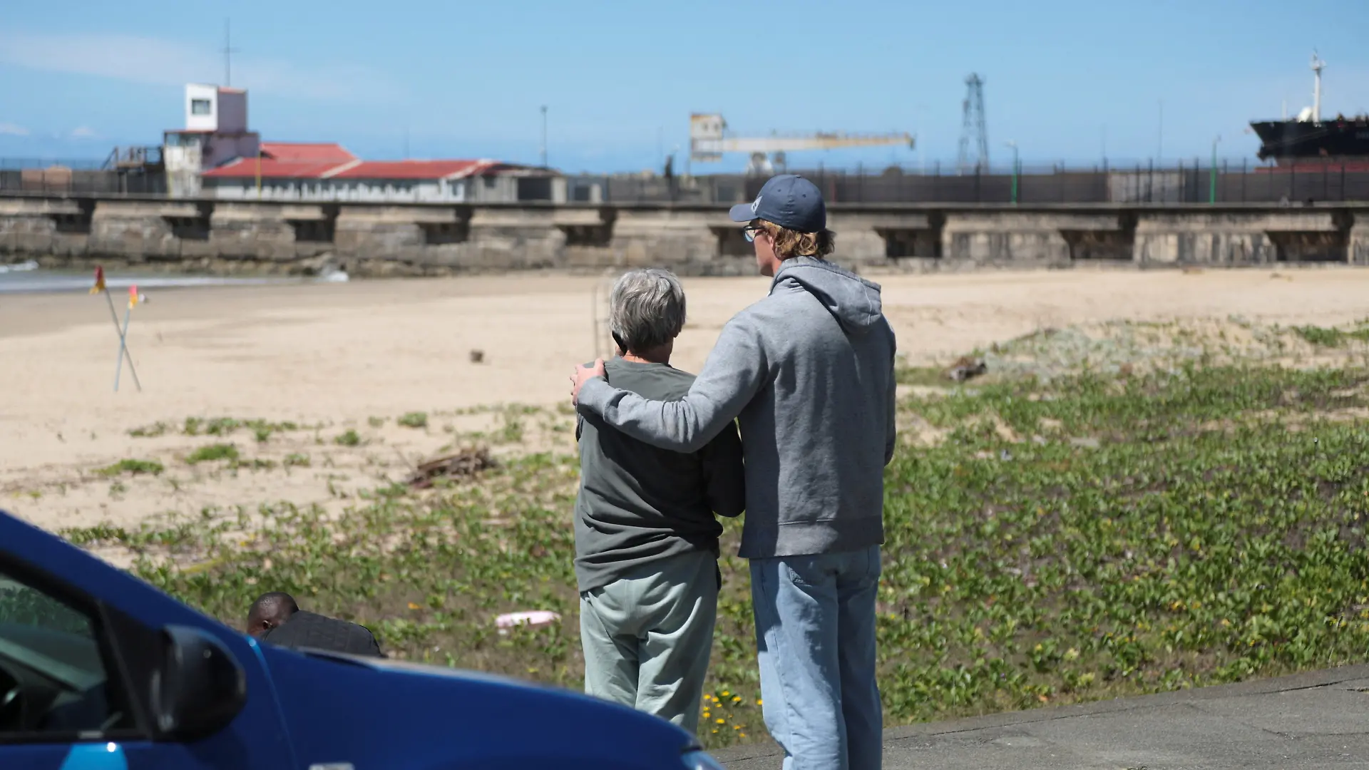 Locals stand near the scene where a woman was killed in a shark attack while swimming off Orient Beach in KuGompo City, Eastern Cape, South Africa, October 20, 2026. REUTERS/Stringer