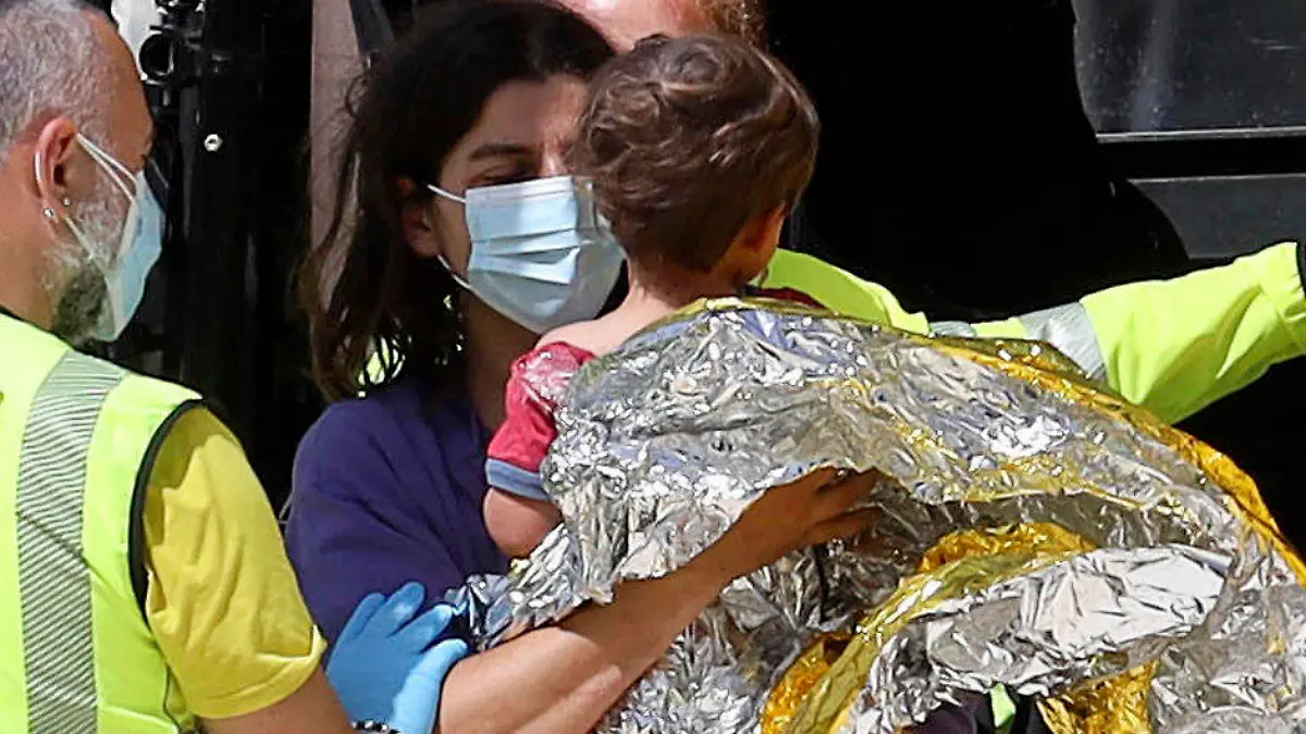 21-month-old Nicola Tanturli is carried by his mother after they were transported by helicopter to Careggi hospital in Florence, Italy, Wednesday, June 23, 2021. The child was found alive Wednesday in the bottom of a ravine after spending two nights alone in the woods near his home in Tuscany. ( Giuseppe CabrasLaPresse via AP)