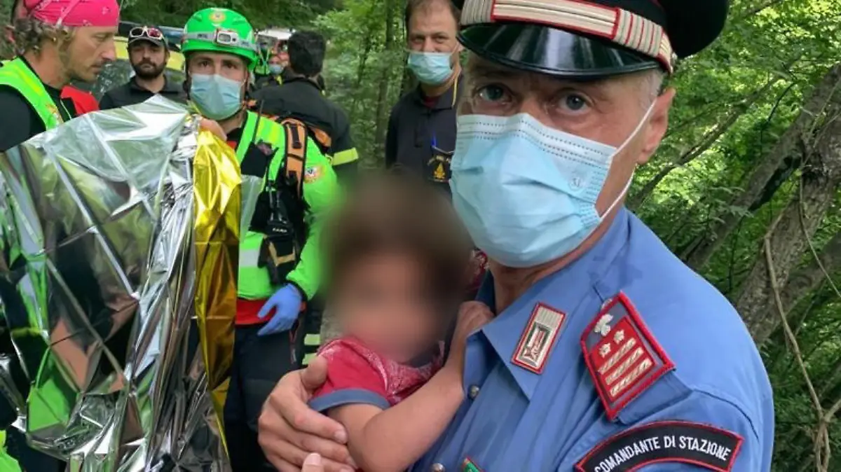 HANDOUT - 23.06.2021, Italien, Palazzuolo sul Senio: Ein Carabinieri hält den kleinen 21 Monate alten Jungen im Arm, der nachts in Palazzuolo sul Senio im Apennin-Gebirge in der Toskana von zu Hause ausgebüxt war und einen großen Sucheinsatz der Rettungskräfte ausgelöst hatte. (zu dpa "Junge nachts ins Gebirge ausgebüxt - stundenlange Suche in Italien") Foto: Carabinieri/dpa - ACHTUNG: Kind wurde aus rechtlichen Gründen gepixelt. Nur zur redaktionellen Verwendung im Zusammenhang mit der aktuellen Berichterstattung. +++ dpa-Bildfunk +++