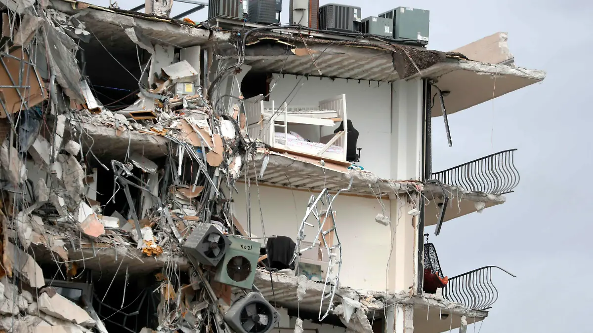 Items and debris dangle from a section of the oceanfront Champlain Towers South Condo that partially collapsed Thursday, June 24, 2021, in the Surfside area of Miami, Fla. (Susan Stocker/South Florida Sun-Sentinel via AP)