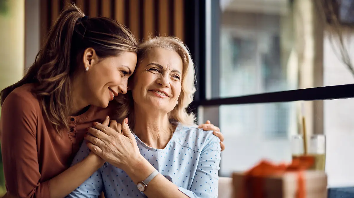Happy senior woman enjoying in daughter's affection on Mother's day.