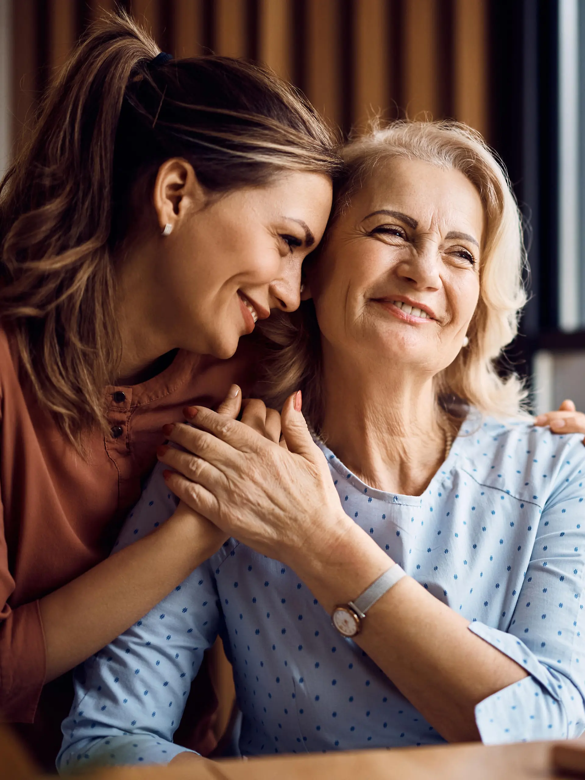 Happy senior woman enjoying in daughter's affection on Mother's day.