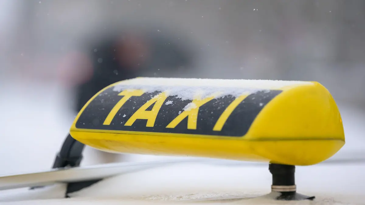 ARCHIV - 08.02.2021, Niedersachsen, Osnabrück: Schneeflocken fallen auf ein Taxi-Schild. Der Weg für eine weitreichende Reform des Taxi- und Fahrdienstmarktes in Deutschland ist frei. (zu dpa «Weg für Reform des Taxi- und Fahrdienstmarktes ist frei») Foto: Jonas Walzberg/dpa +++ dpa-Bildfunk +++