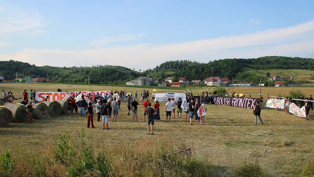 People take part in a protest against the violent pushbacks of migrants, allegedly conducted by Croatian police, near the border crossing between Croatia and Bosnia Herzegovina in Maljevac, Croatia, Saturday, June 19, 2021. More than one hundred members of human rights NGO's, mostly from Italy, but also from Germany, Austria, Spain and Slovenia blocked the border traffic for about two hours protesting demanding a stop of all deportation of migrants, and cancellation of EU's Frontex operations at borders, preventing migrants from traveling. (AP Photo/Edo Zulic)
