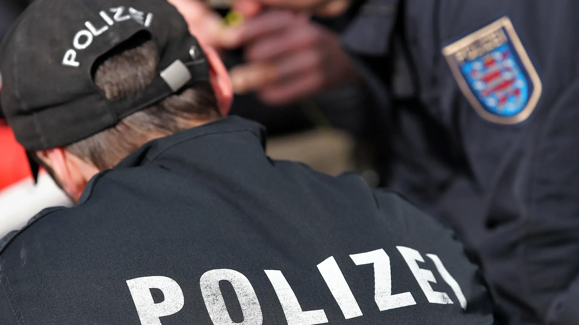 Der Schriftzug "Polizei" und das Logo von Thüringen stehen am Dienstag (10.04.2012) auf den Uniformen von zwei Polizeibeamten in Markkleeberg (Leipzig). Foto: Jan Woitas | Verwendung weltweit