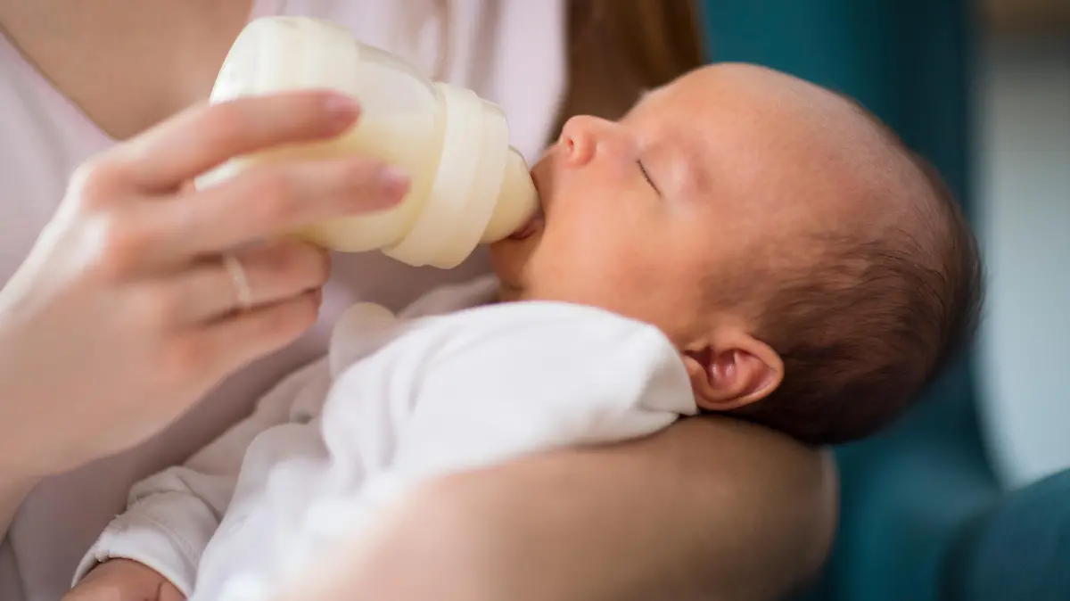 Baby trinkt Milch aus der Flasche