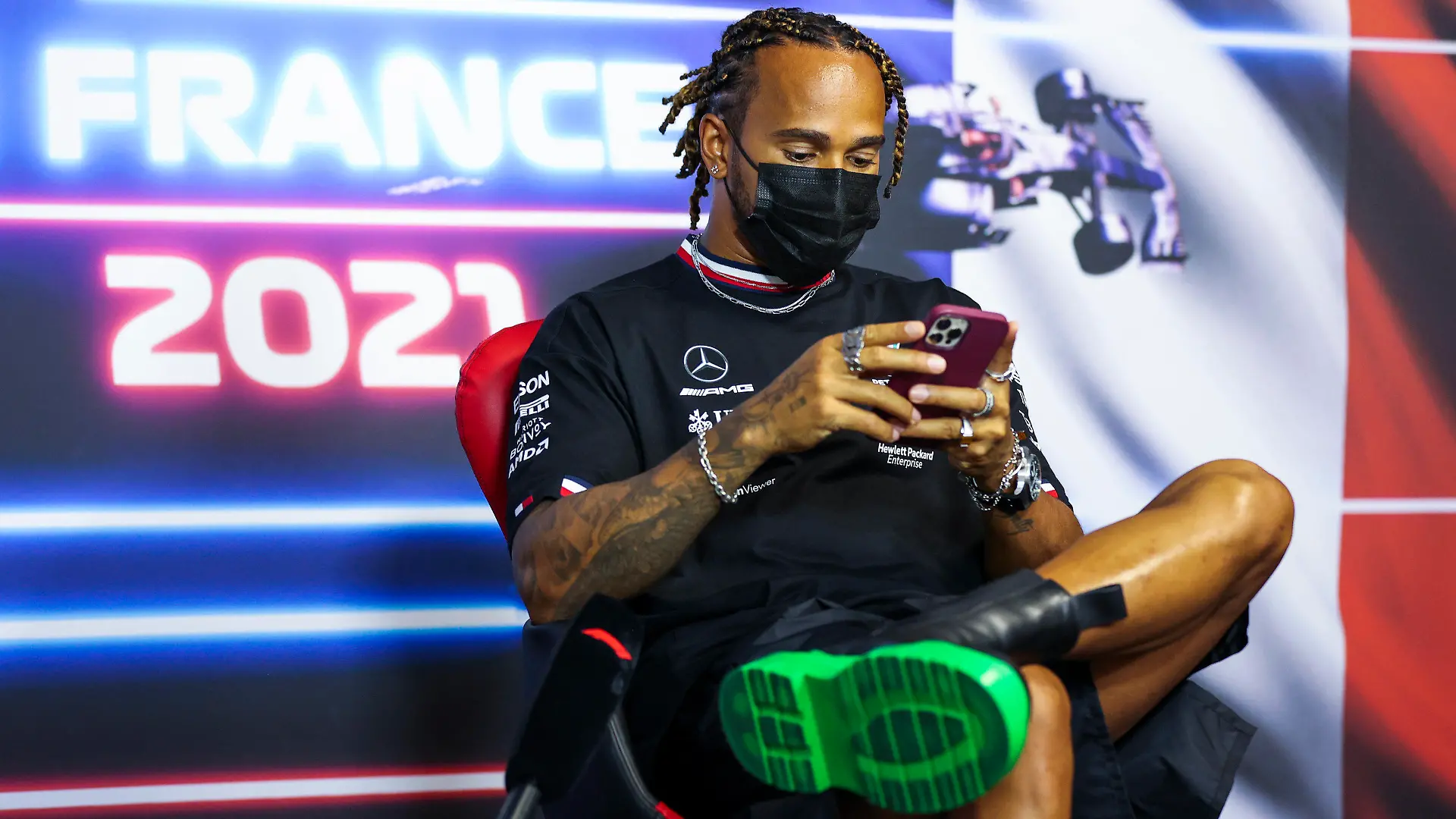 Mercedes driver Lewis Hamilton of Britain checks his smartphone as he attends a press conference ahead of the French Formula One Grand Prix at the Paul Ricard racetrack in Le Castellet, southern France, Thursday, June 17, 2021. The French Grand Prix will be held on Sunday. (Antonin Vincent, Pool via AP)