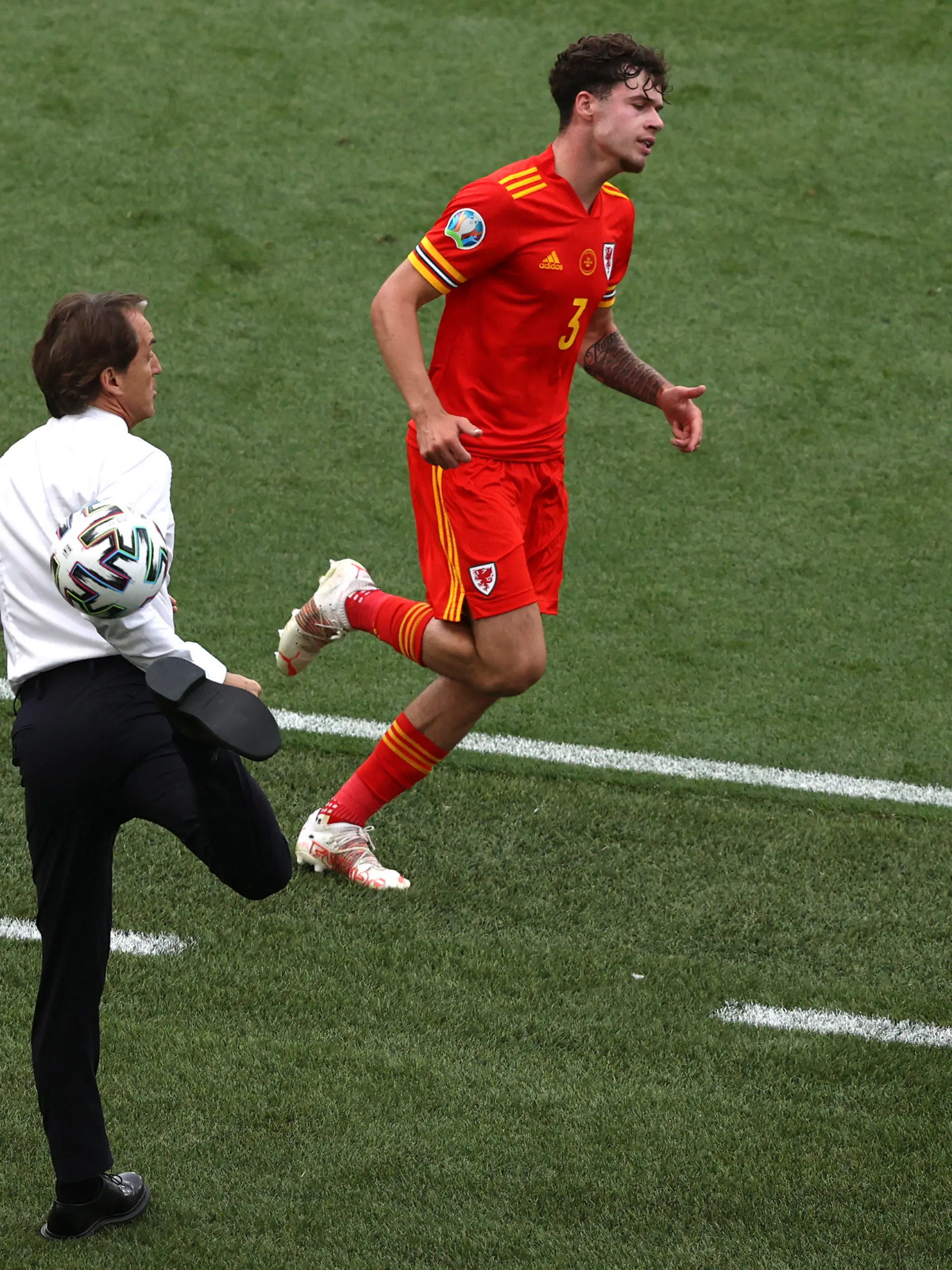 20.06.2021, Italien, Rome: Fußball, EM, Italien - Wales, Vorrunde, Gruppe A, 3. Spieltag, Stadio Olimpico di Roma: Italiens Trainer Roberto Mancini stoppt den Ball neben Wales' Neco Williams.     (zu dpa "Italien-Coach Mancini und der Hackentrick: «Er kann es noch!»") Foto: Ryan Pierse/Getty Pool/dpa +++ dpa-Bildfunk +++