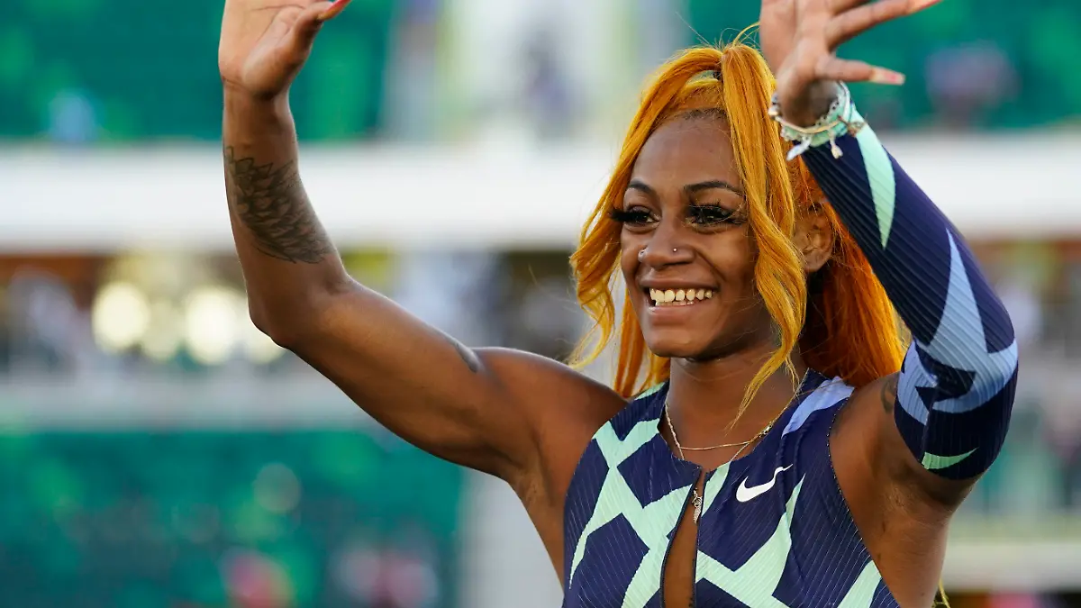 Sha'Carri Richardson waves after winning the women's 100-meter run at the U.S. Olympic Track and Field Trials Saturday, June 19, 2021, in Eugene, Ore. (AP Photo/Ashley Landis)
