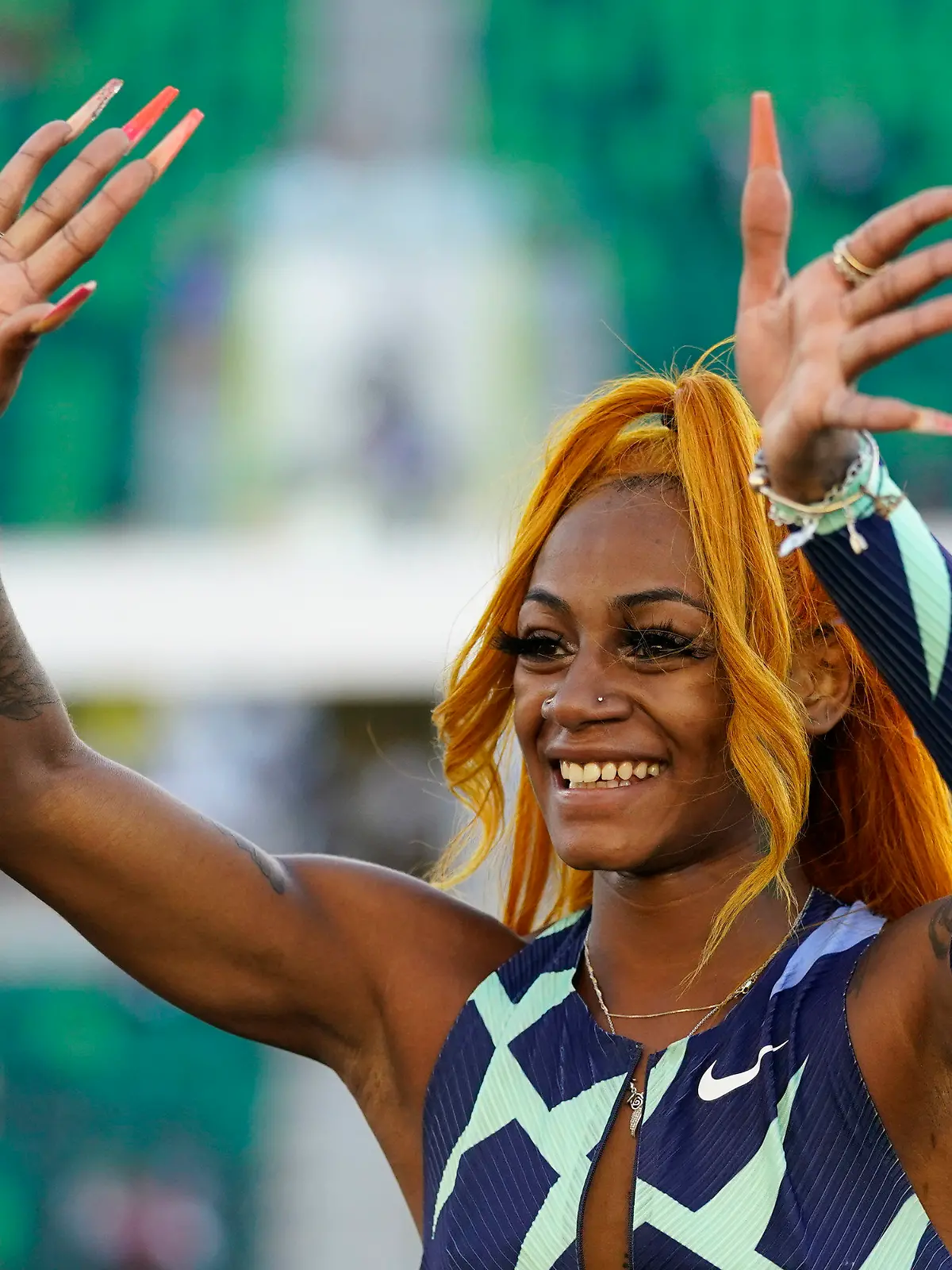 Sha'Carri Richardson waves after winning the women's 100-meter run at the U.S. Olympic Track and Field Trials Saturday, June 19, 2021, in Eugene, Ore. (AP Photo/Ashley Landis)