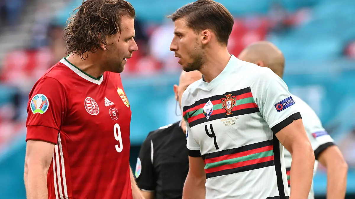 Hungary's Adam Szalai, left, argues with Portugal's Ruben Dias during the Euro 2020 soccer championship group F match between Hungary and Portugal at the Ferenc Puskas stadium in Budapest, Hungary, Tuesday, June 15, 2021. (Tibor Illyes/Pool via AP)