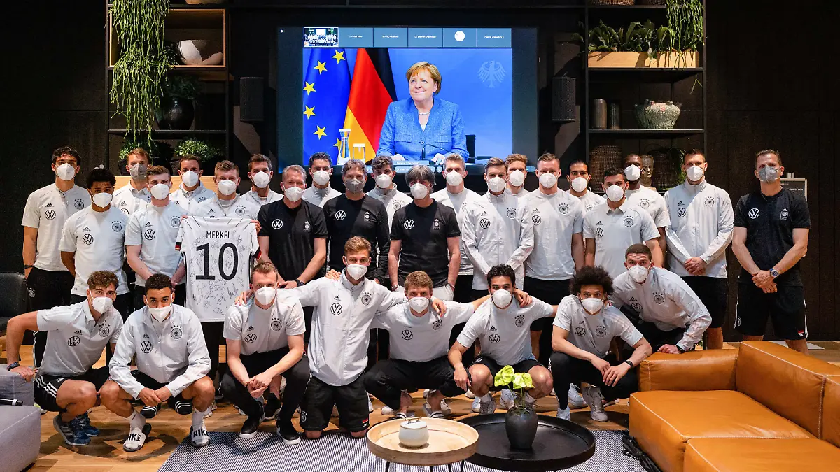 HERZOGENAURACH, GERMANY - JUNE 11: German Chancellor of Germany Angela Merkel addresses the German National Team from a video screen and sends best wishes ahead of the start of the UEFA European Championship 2020 at the Team Base Camp on June 11, 2021 in Herzogenaurach, Germany. (Photo by Pool/Philipp Reinhard-Pool/Getty Images)