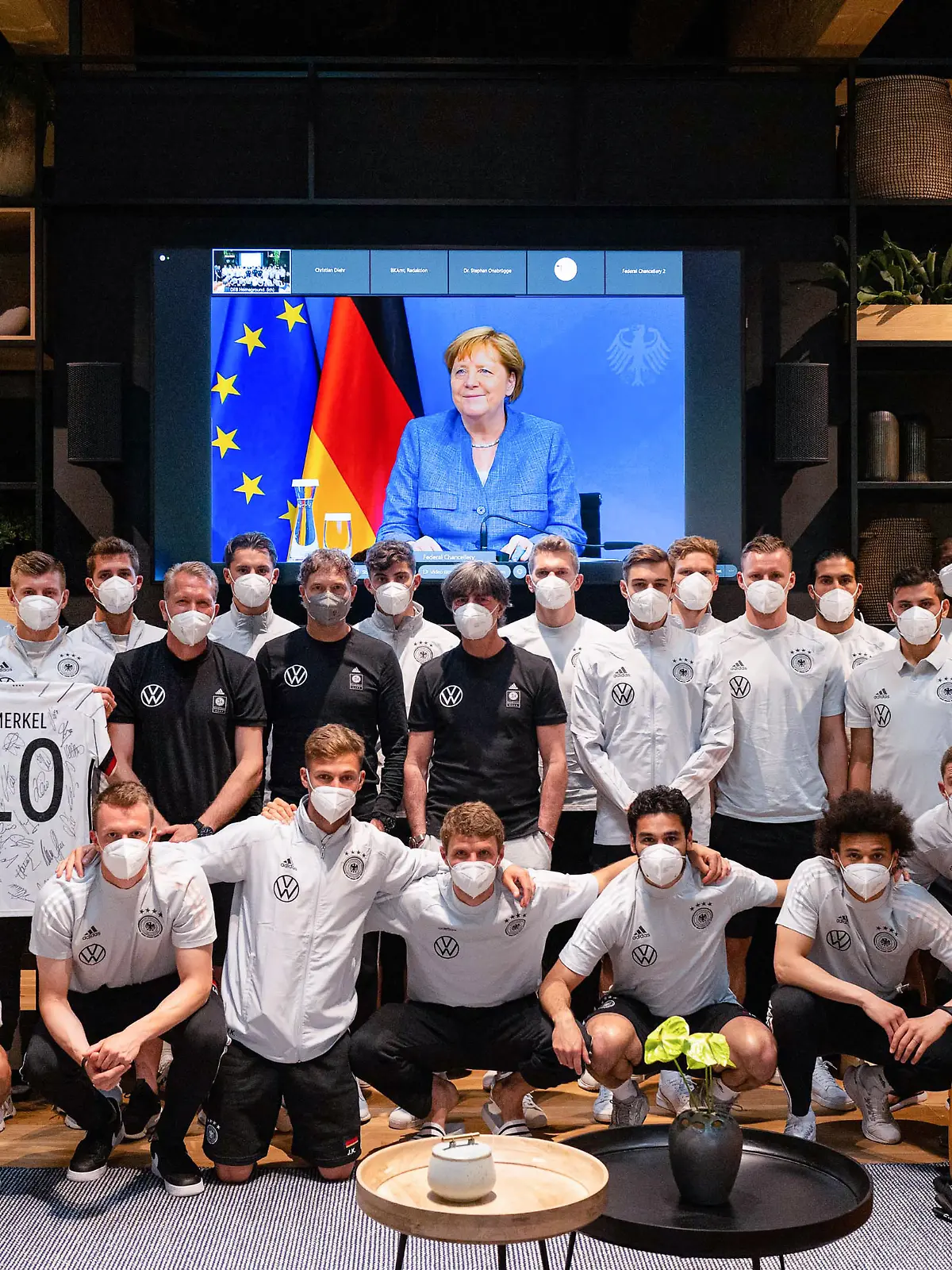 HERZOGENAURACH, GERMANY - JUNE 11: German Chancellor of Germany Angela Merkel addresses the German National Team from a video screen and sends best wishes ahead of the start of the UEFA European Championship 2020 at the Team Base Camp on June 11, 2021 in Herzogenaurach, Germany. (Photo by Pool/Philipp Reinhard-Pool/Getty Images)