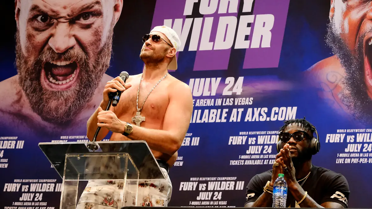 WBC Heavyweight Champion Tyson Fury, left talks during a news conference as Deontay Wilder looks on in Los Angeles on Tuesday, June 15, 2021, in anticipation of their third heavyweight championship showdown scheduled for July 24 in Las Vegas. (AP Photo/Richard Vogel)