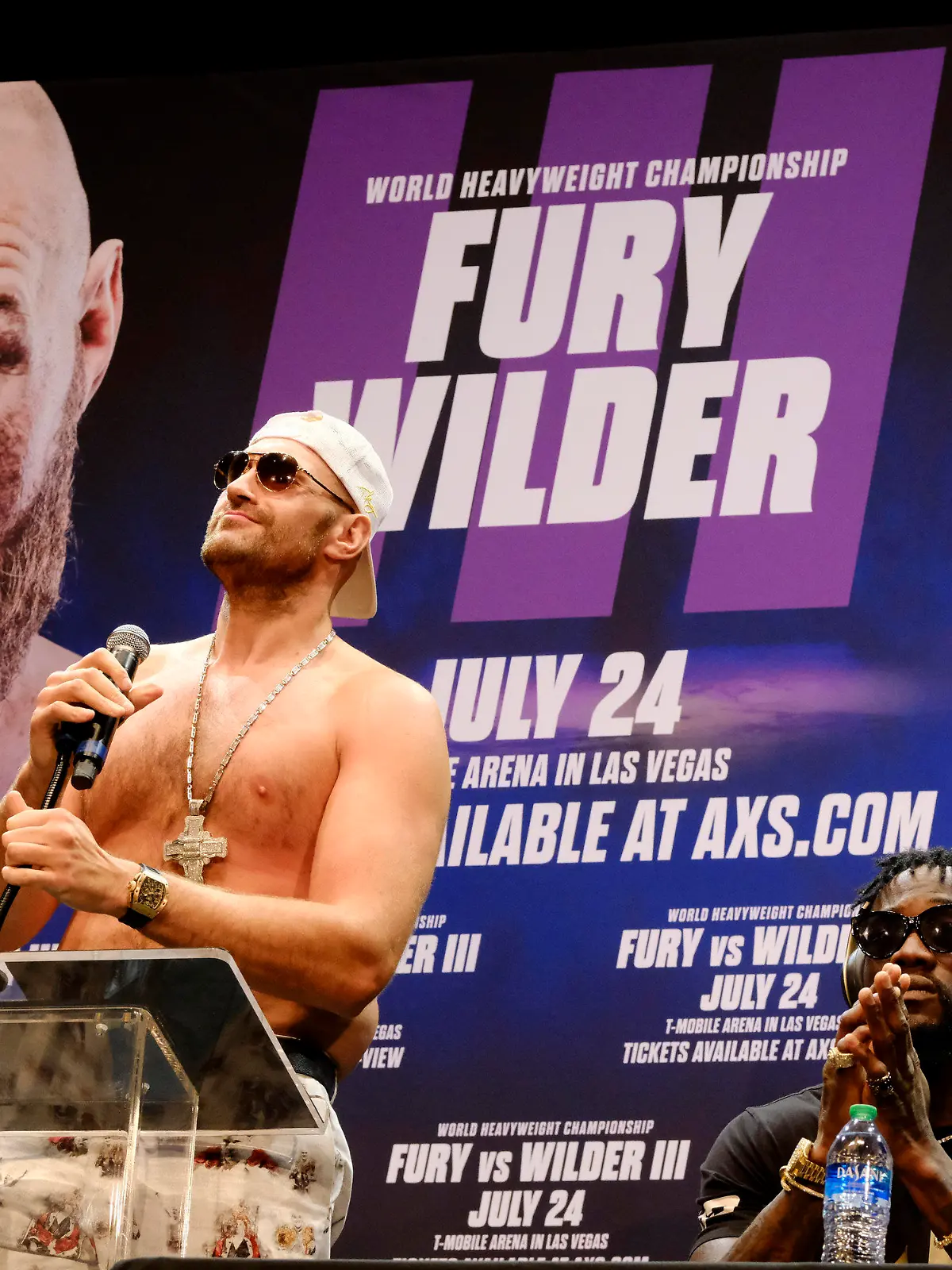 WBC Heavyweight Champion Tyson Fury, left talks during a news conference as Deontay Wilder looks on in Los Angeles on Tuesday, June 15, 2021, in anticipation of their third heavyweight championship showdown scheduled for July 24 in Las Vegas. (AP Photo/Richard Vogel)