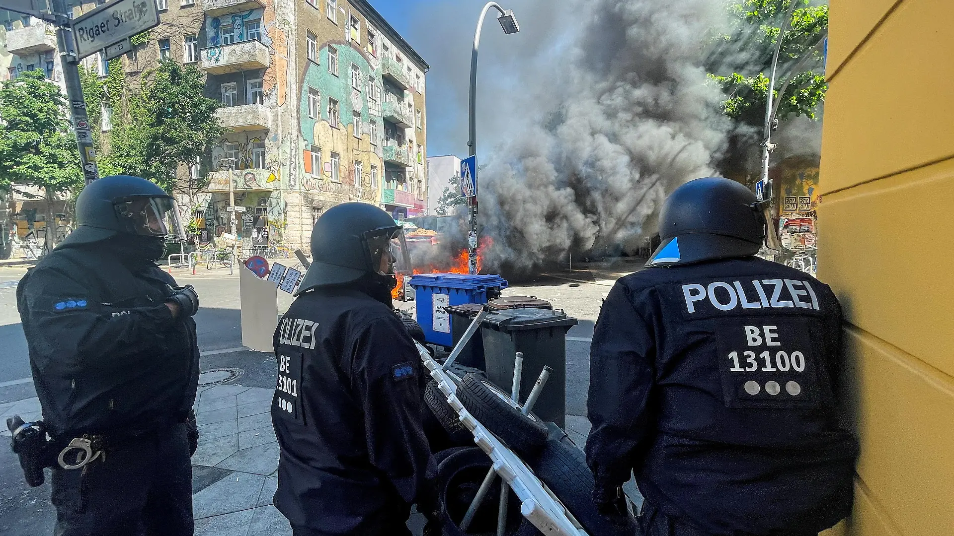 Police officers stand near burning barricades at Rigaer Street in Berlin, Germany, June 16, 2021. REUTERS/Hannibal Hanschke REFILE- CORRECTING YEAR