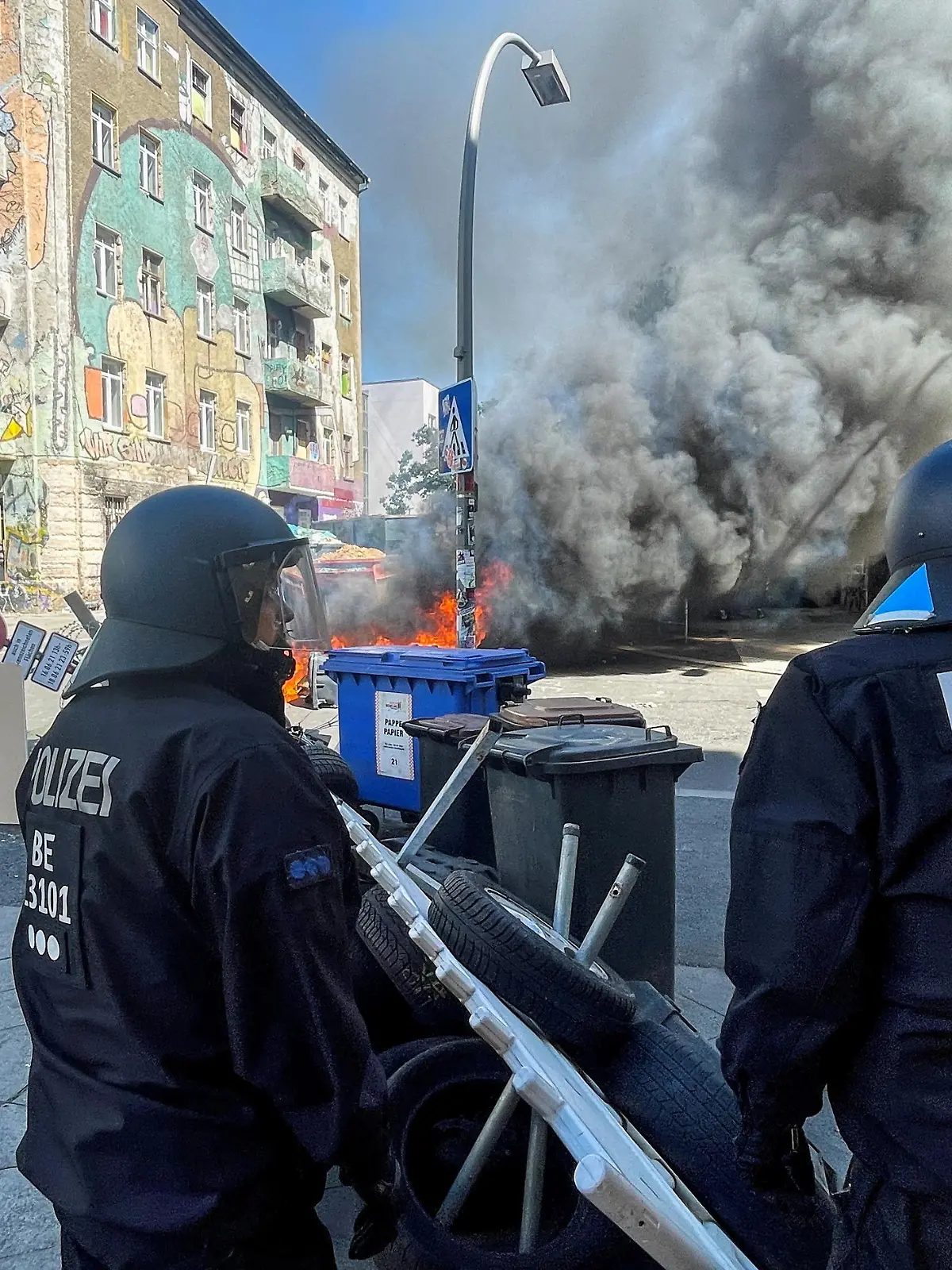 Police officers stand near burning barricades at Rigaer Street in Berlin, Germany, June 16, 2021. REUTERS/Hannibal Hanschke REFILE- CORRECTING YEAR