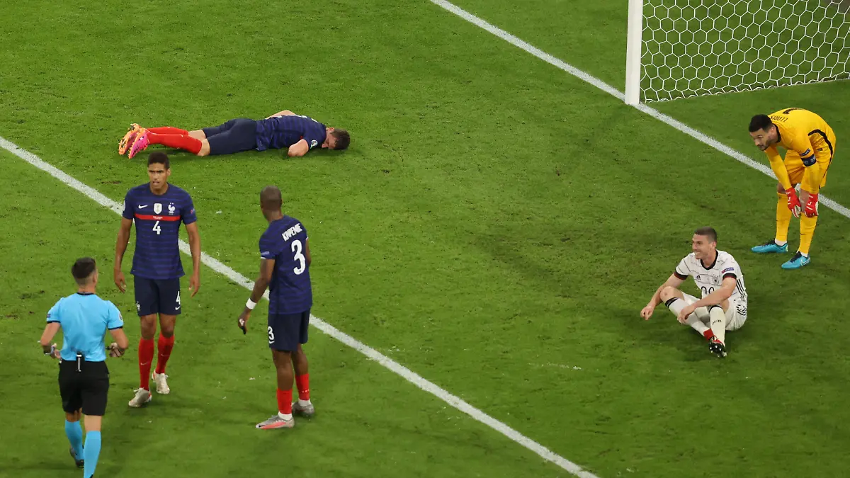 Soccer Football - Euro 2020 - Group F - France v Germany - Football Arena Munich, Munich, Germany - June 15, 2021 France's Benjamin Pavard reacts on the ground after sustaining an injury Pool via REUTERS/Alexander Hassenstein