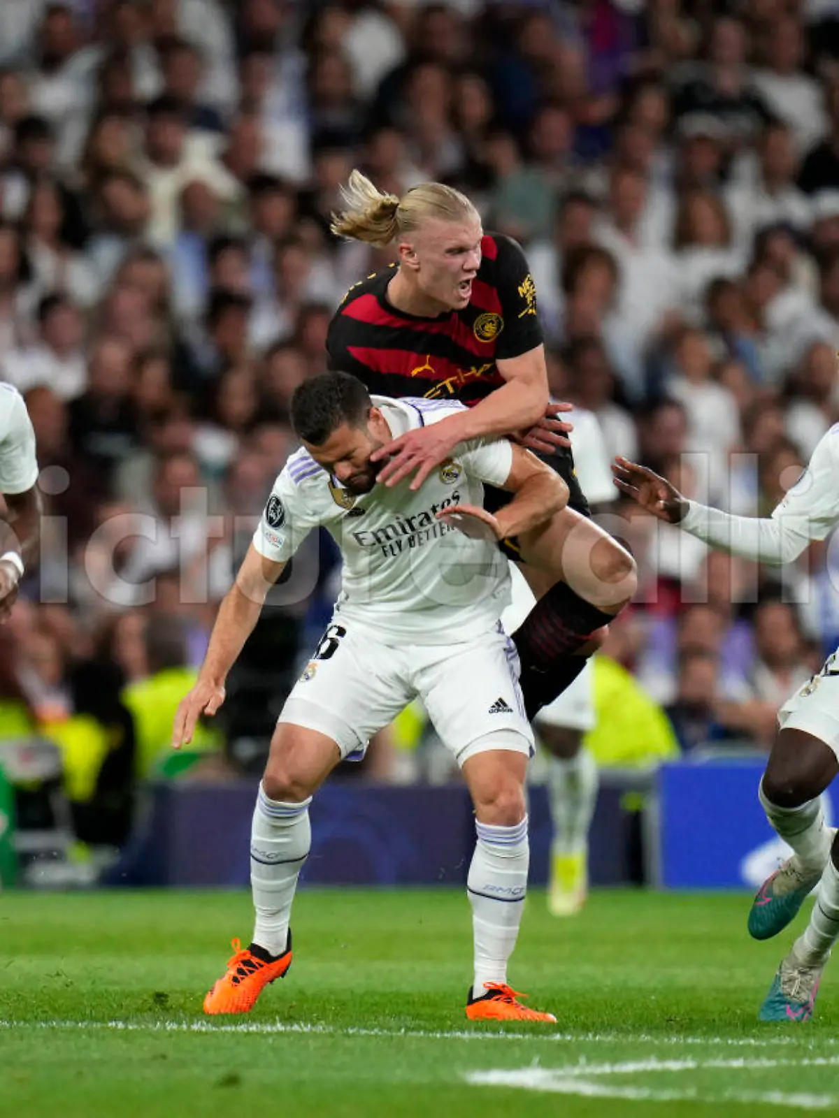 Manchester City's Erling Haaland, top center, is challenged by Real Madrid's Nacho during the Champions League semifinal first leg soccer match between Real Madrid and Manchester City at the Santiago Bernabeu stadium in Madrid, Spain, Tuesday, May 9, 2023. (AP Photo/Manu Fernandez)