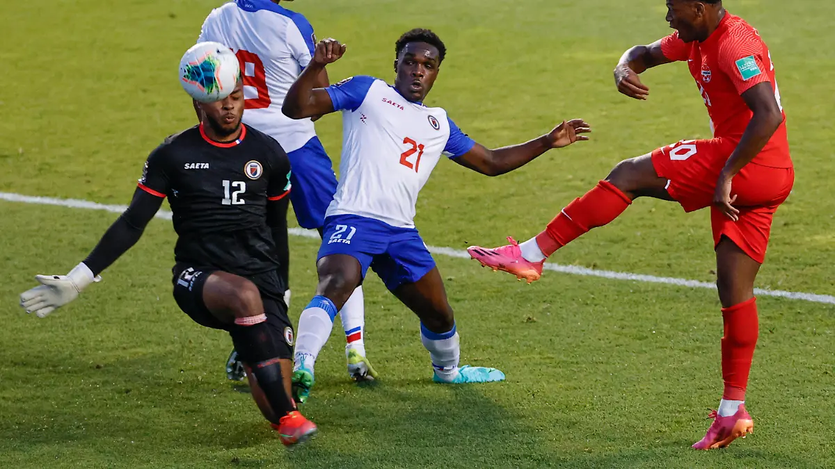 Canada's Jonathan David (20) tries to score against Haiti's Josue Duverger (12) and Bryan Alceus (21) during the first half of a World Cup qualifying soccer match Tuesday, June 15, 2021, in Bridgeview, Ill. (AP Photo/Kamil Krzaczynski)