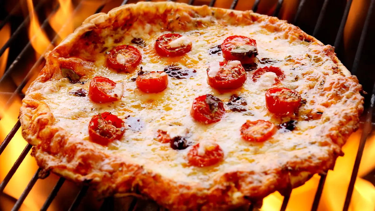Pizza with Fresh Mozzarella,Tomatoes and Basil on the BBQ - Photographed on a Hasselblad H3D11-39 megapixel Camera System