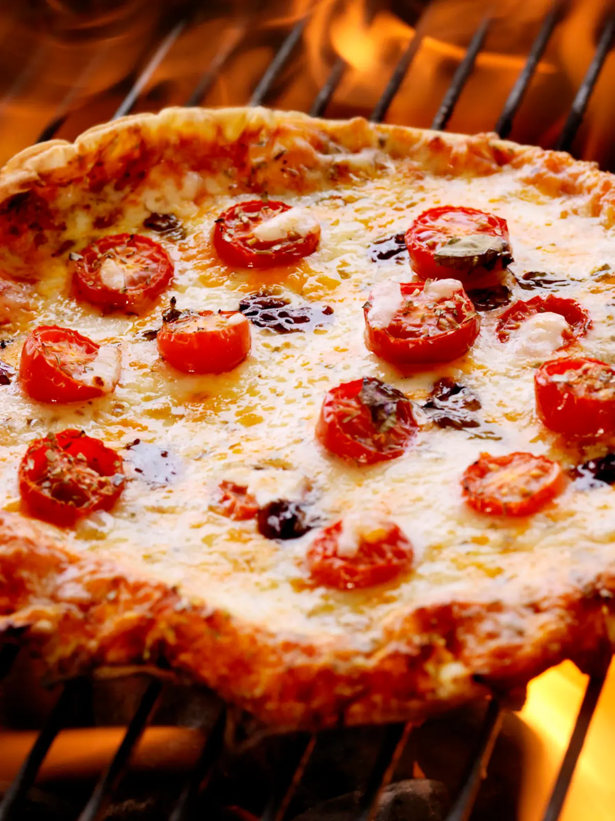Pizza with Fresh Mozzarella,Tomatoes and Basil on the BBQ - Photographed on a Hasselblad H3D11-39 megapixel Camera System