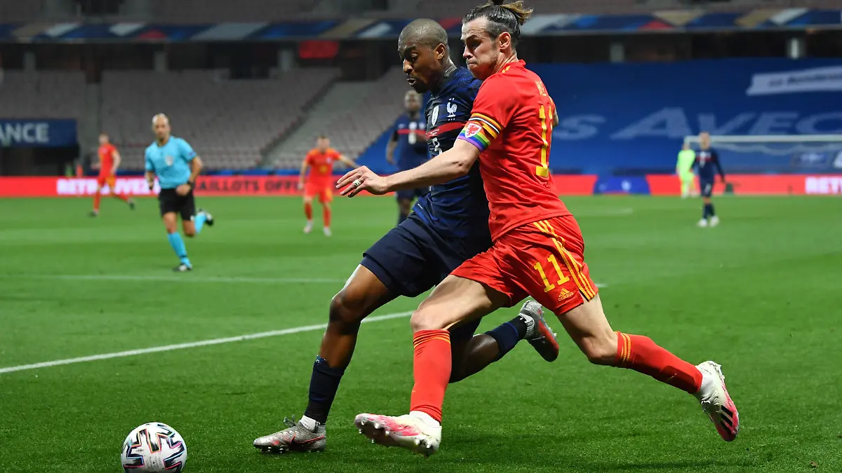 NICE, FRANCE - JUNE 02: Gareth Bale of Wales battles for possession with Presnel Kimpembe of France  during the international friendly match between France and Wales at Allianz Riviera on June 02, 2021 in Nice, France. (Photo by Valerio Pennicino/Getty Images)
