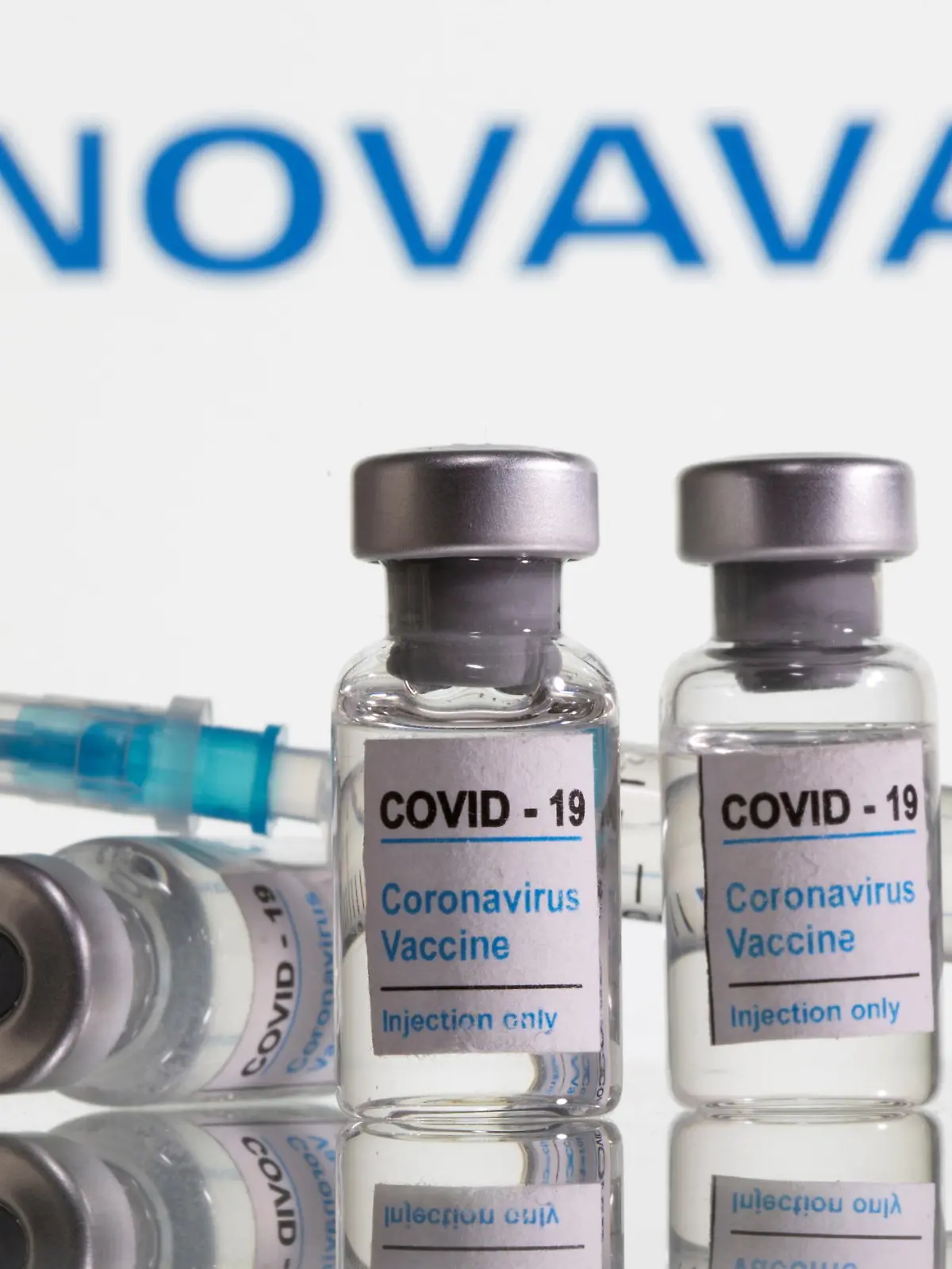 FILE PHOTO: Vials labelled "COVID-19 Coronavirus Vaccine" and syringe are seen in front of displayed Novavax logo in this illustration taken, February 9, 2021. REUTERS/Dado Ruvic/Illustration/File Photo