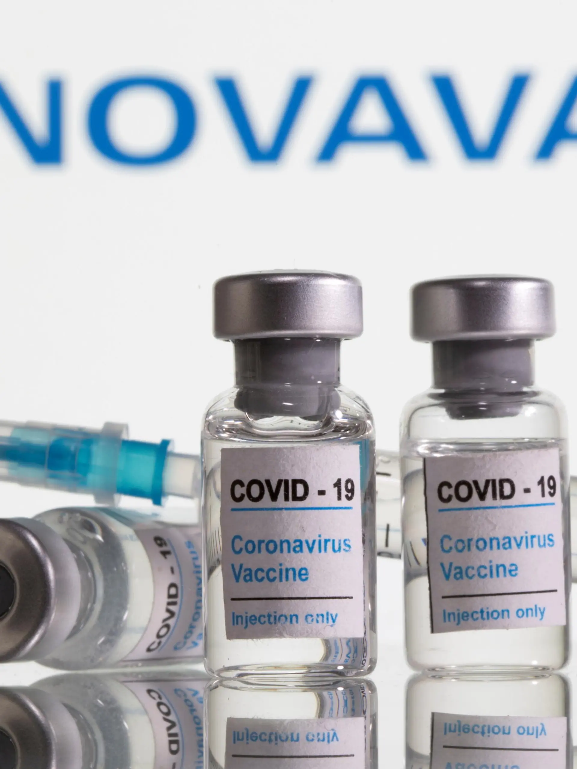FILE PHOTO: Vials labelled "COVID-19 Coronavirus Vaccine" and syringe are seen in front of displayed Novavax logo in this illustration taken, February 9, 2021. REUTERS/Dado Ruvic/Illustration/File Photo