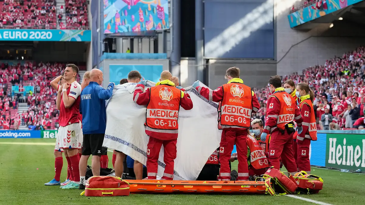 COPENHAGEN, DENMARK - JUNE 12: Medics surround Christian Eriksen of Denmark as he receives treatment during the UEFA Euro 2020 Championship Group B match between Denmark and Finland on June 12, 2021 in Copenhagen, Denmark. (Photo by Martin Meissner - Pool/Getty Images)