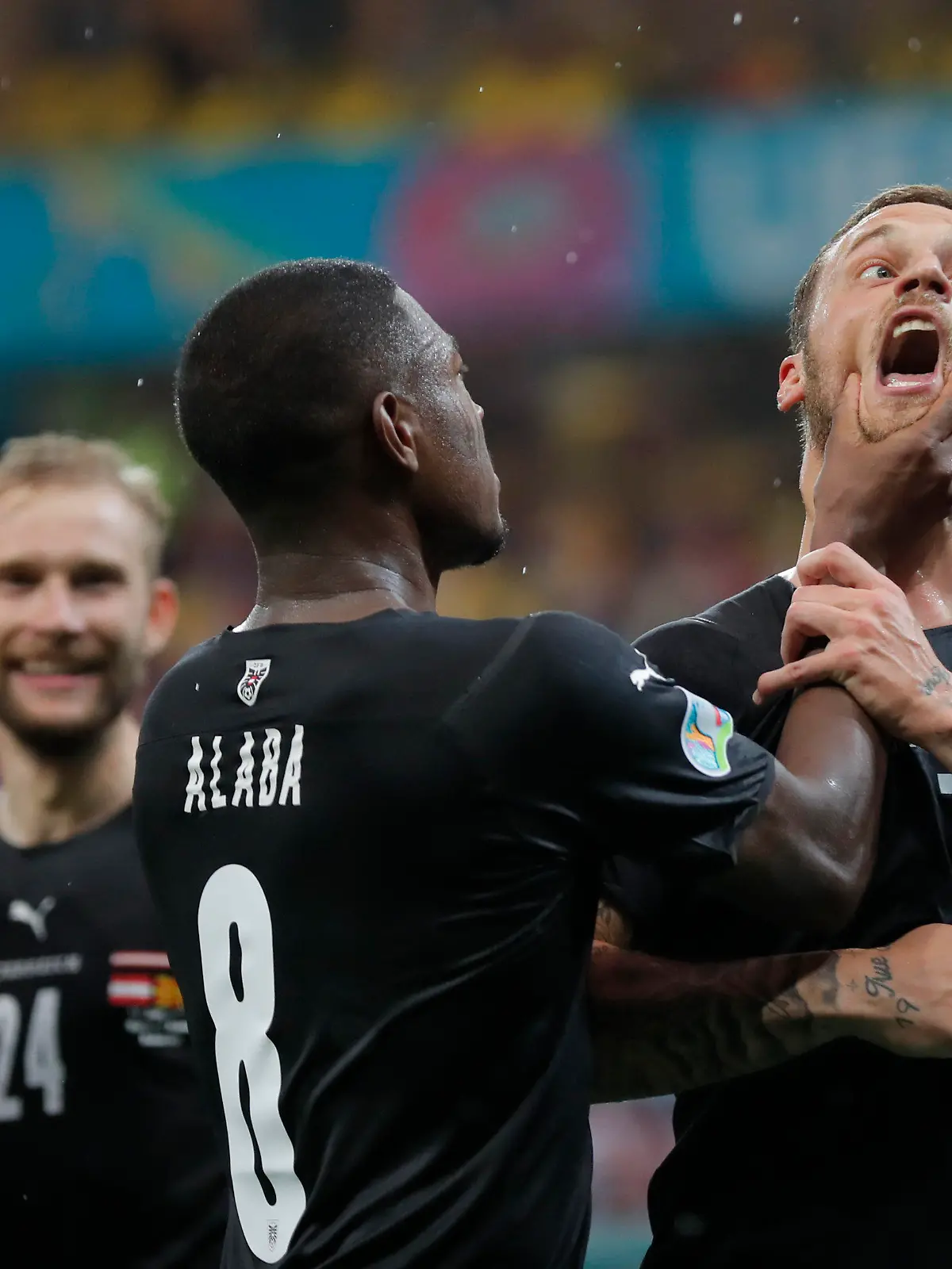 Austria's Marko Arnautovic, right, celebrates with Austria's David Alaba after scoring his side's third goal during the Euro 2020 soccer championship group C match between Austria and Northern Macedonia at the National Arena stadium in Bucharest, Romania, Sunday, June 13, 2021. (Robert Ghement/Pool via AP)