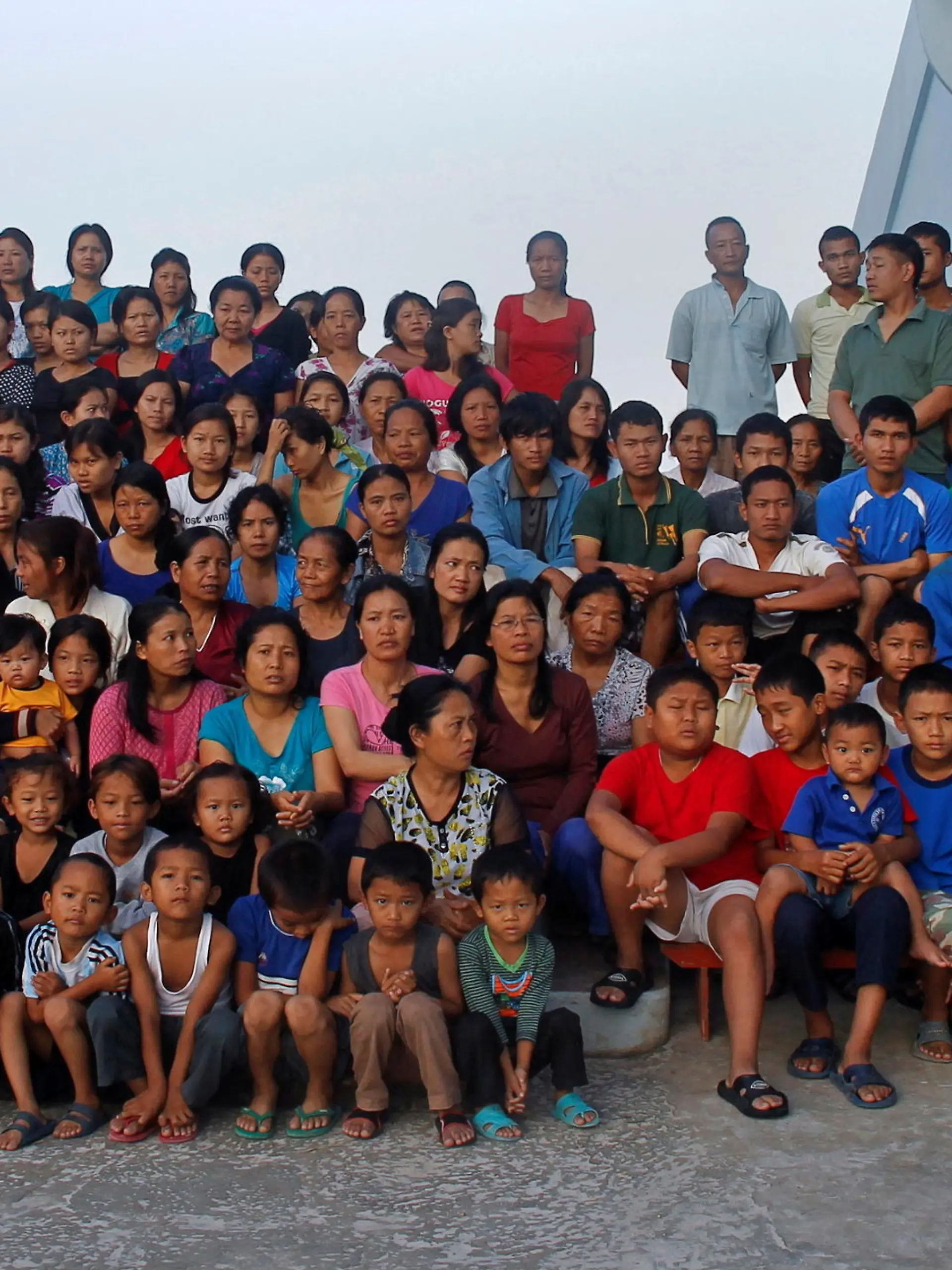 FILE PHOTO: ATTN EDITORS: IMAGE 17 OF 51 OF PICTURE PACKAGE '7 BILLION, 7 STORIES - THE WORLD'S LARGEST FAMILY'. SEARCH 'BAKTAWNG' TO SEE ALL IMAGES  Family members of Ziona (R) poses for group photograph outside their residence in Baktawng village in the northeastern Indian state of Mizoram, October 7, 2011. Ziona is the head of a religious sect called "Chana," which allows polygamy and was founded by his father Chana in 1942. Ziona has 39 wives, 94 children and 33 grandchildren. He lives in his 4 storey 100-room house with 181 members of his family. The world's population will reach seven billion on 31 October 2011, according to projections by the United Nations.   Picture taken October 7, 2011.  REUTERS/Adnan Abidi (INDIA  - Tags: SOCIETY)   FOR BEST QUALITY IMAGE: ALSO SEE  GF2E7BI0OV501/File Photo