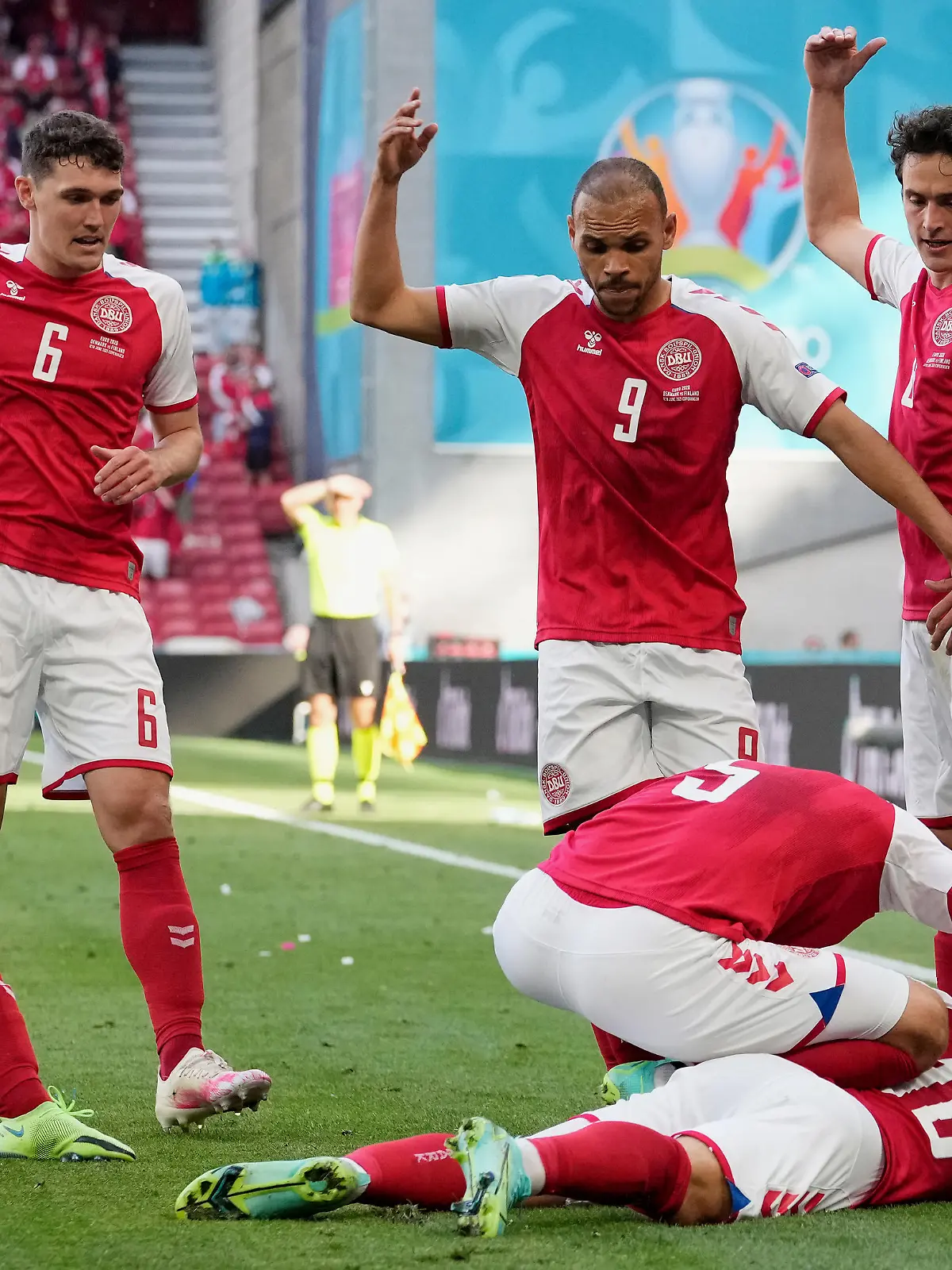 COPENHAGEN, DENMARK - JUNE 12: Christian Eriksen of Denmark goes down injured as team mates (L - R) Simon Kjaer, Andreas Christensen, Martin Braithwaite and Thomas Delaney call for assistance during the UEFA Euro 2020 Championship Group B match between Denmark and Finland on June 12, 2021 in Copenhagen, Denmark. (Photo by Martin Meissner - Pool/Getty Images)