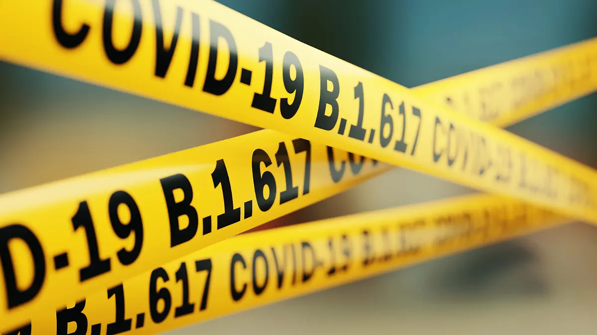Absperrbänder beschriftet mit Covid-19 B1.6176