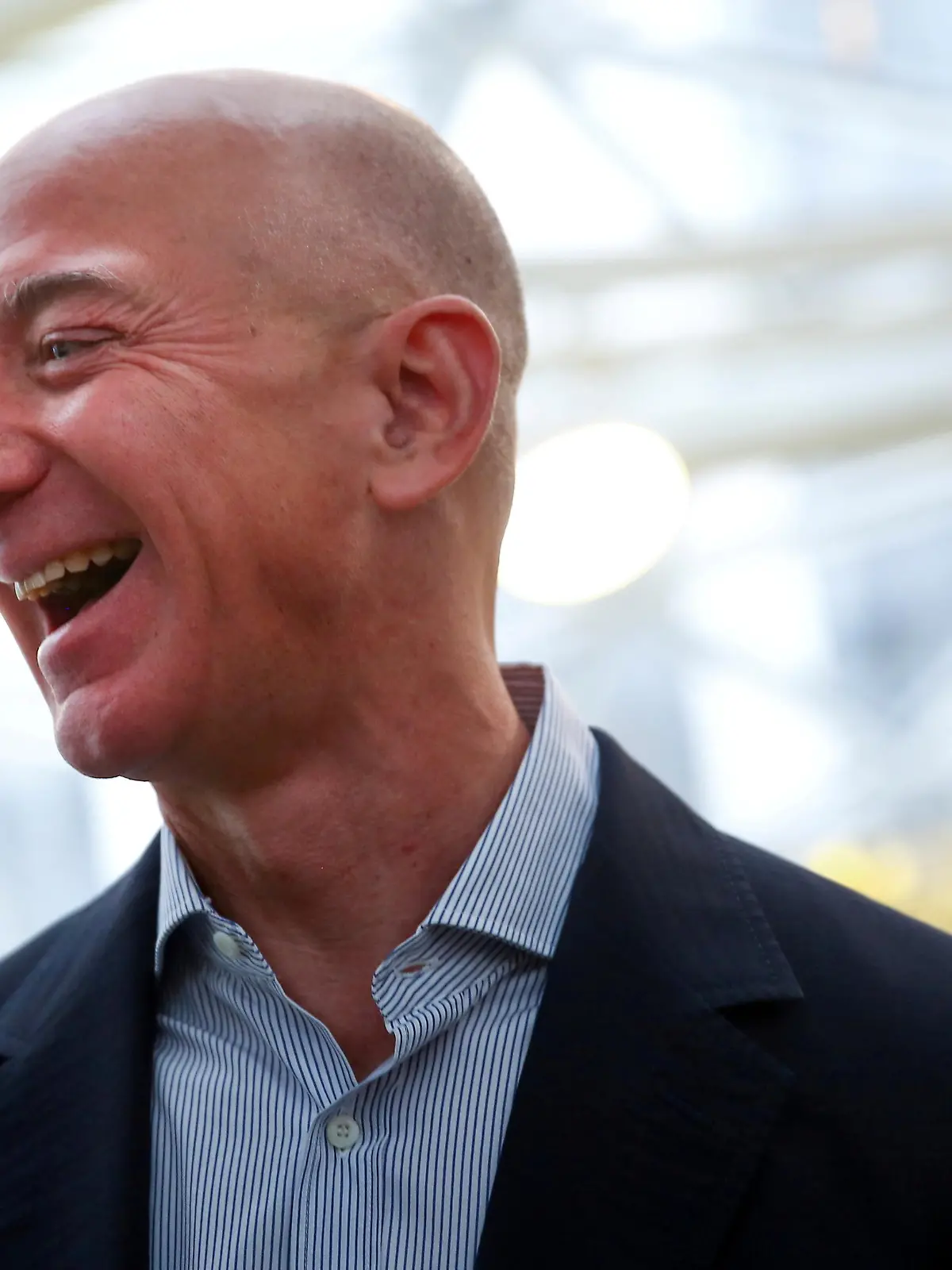 FILE PHOTO: Amazon founder and CEO Jeff Bezos laughs as he talks to the media while touring the new Amazon Spheres during the grand opening at Amazon's Seattle headquarters in Seattle, Washington, U.S., January 29, 2018.   REUTERS/Lindsey Wasson/File Photo