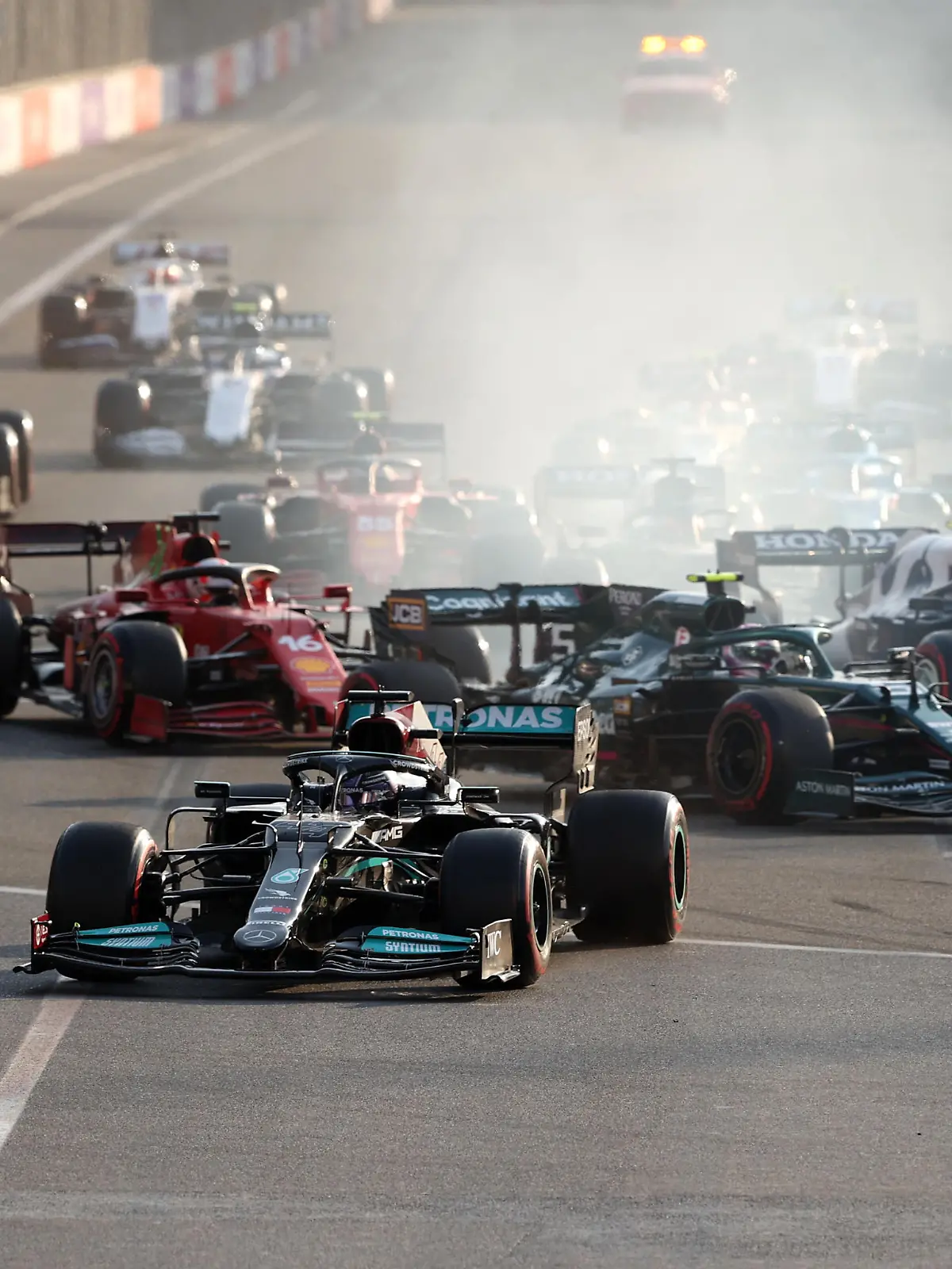 BAKU, AZERBAIJAN - JUNE 06: Lewis Hamilton of Great Britain driving the (44) Mercedes AMG Petronas F1 Team Mercedes W12 runs wide after locking up at the restart following a red flag period during the F1 Grand Prix of Azerbaijan at Baku City Circuit on June 06, 2021 in Baku, Azerbaijan. (Photo by Clive Rose/Getty Images)
