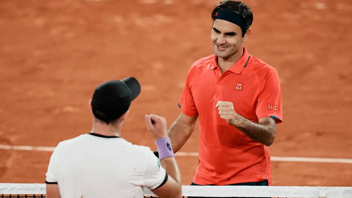 Switzerland's Roger Federer, right goes to shake hands with Germany's Dominik Koepfer, after defeating him in their third round match on day 7, of the French Open tennis tournament at Roland Garros in Paris, France, Saturday, June 5, 2021. (AP Photo/Thibault Camus)