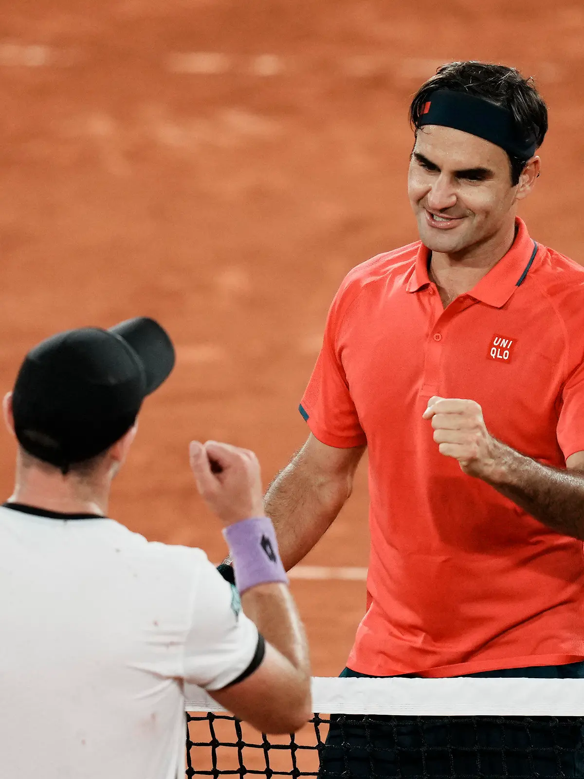 Switzerland's Roger Federer, right goes to shake hands with Germany's Dominik Koepfer, after defeating him in their third round match on day 7, of the French Open tennis tournament at Roland Garros in Paris, France, Saturday, June 5, 2021. (AP Photo/Thibault Camus)
