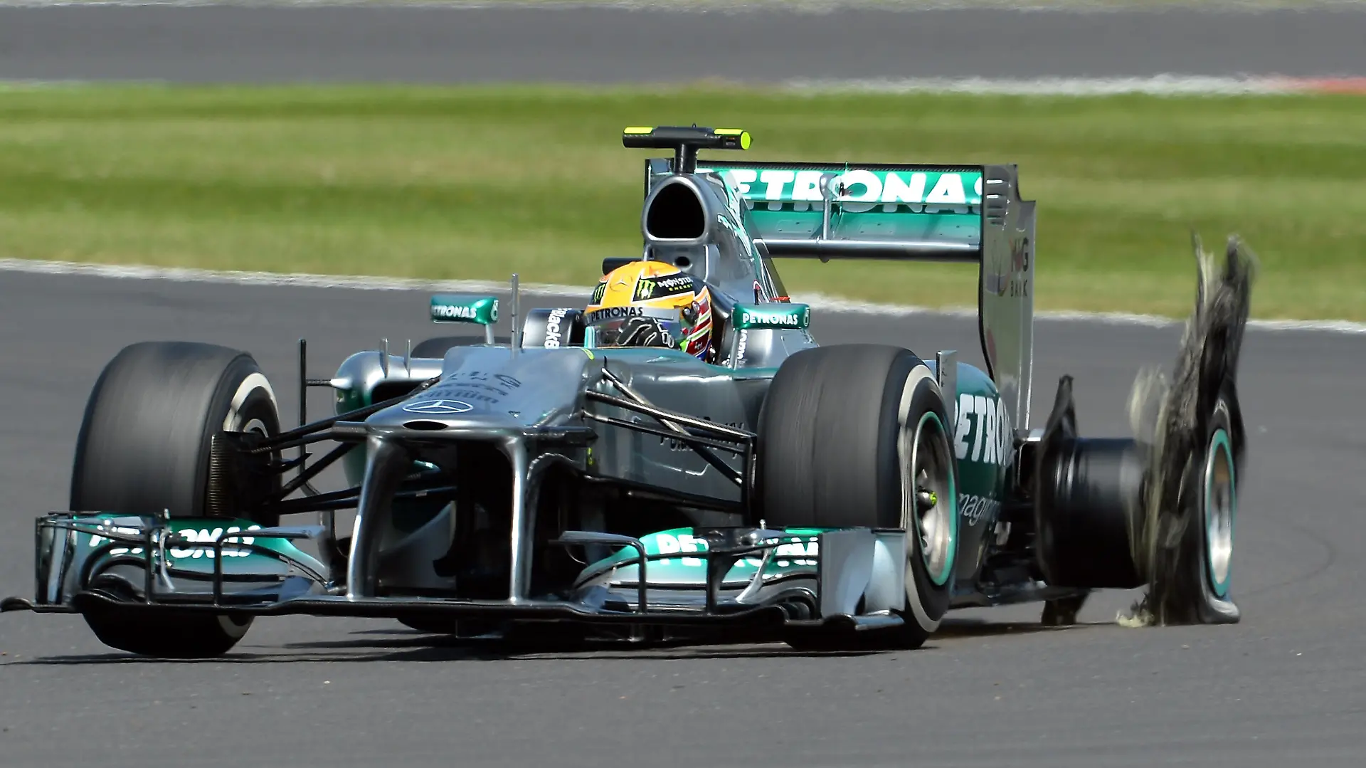 NORTHAMPTON, ENGLAND - JUNE 30: Lewis Hamilton of Great Britain and Mercedes GP has a left rear tyre failure during the British Formula One Grand Prix at Silverstone Circuit on June 30, 2013 in Northampton, England. (Photo by Lars Baron/Getty Images)