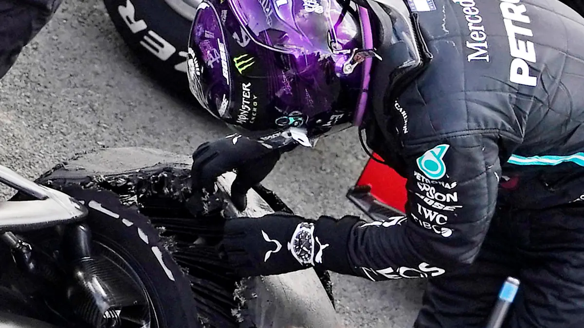 Formula One F1 - British Grand Prix - Silverstone Circuit, Silverstone, Britain - August 2, 2020 Mercedes' Lewis Hamilton looks at his tyre after winning the race with a puncture on the final lap Pool via REUTERS/Will Oliver
