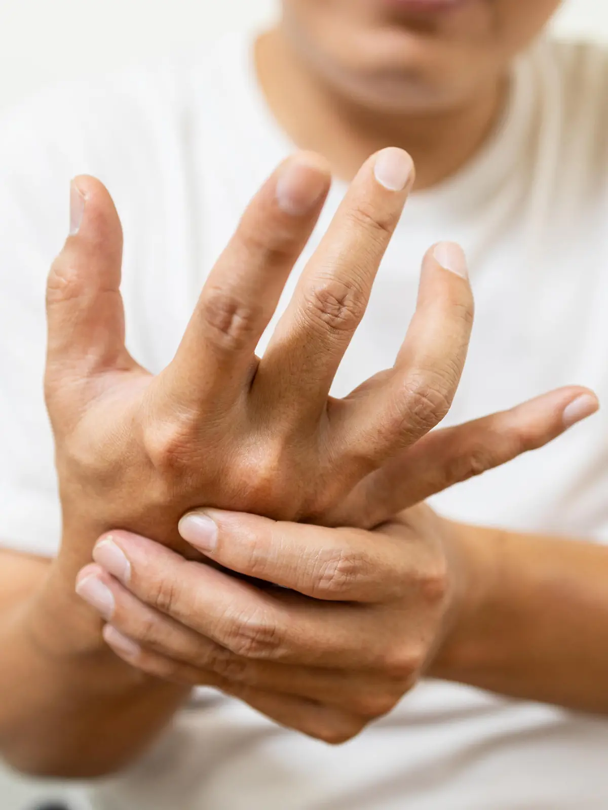 Close up,asian middle-aged man with shaking of Parkinson's disease,symptom of resting tremor,male patient holding her hand to control hands tremor,neurological disorders,brain problems,health care