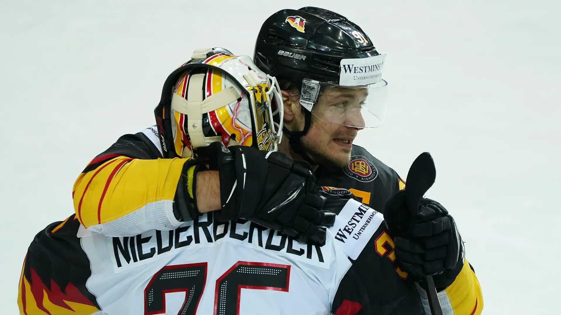 01.06.2021, Lettland, Riga: Eishockey: Weltmeisterschaft, Viertelfinale, Schweiz - Deutschland: Deutschlands Moritz Müller (hinten) und Torwart Mathias Niederberger umarmen sich nach dem Spiel. Die deutsche Eishockey-Nationalmannschaft gewann das Viertelfinale gegen die Schweiz 3:2 nach Penaltyschießen und spielt damit um die erste WM-Medaille seit 1953. Foto: Roman Koksarov/dpa +++ dpa-Bildfunk +++