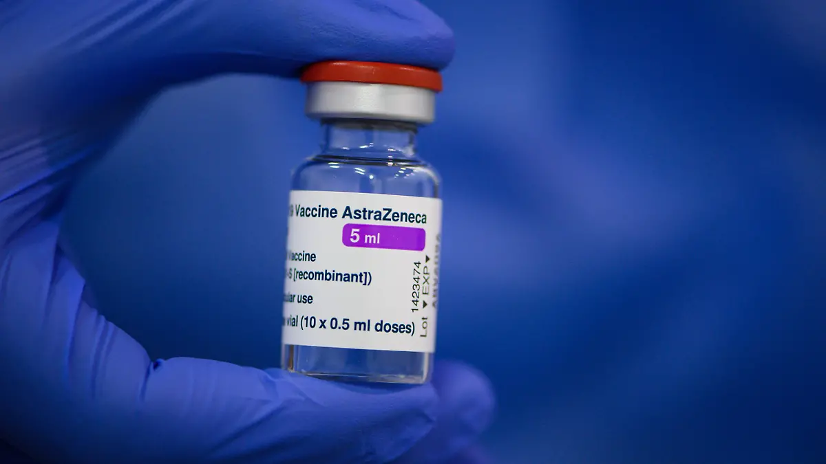ARCHIV - 20.03.2021, Sachsen, Dresden: Ein Mitarbeiter im Impfzentrum in der Messe Dresden hält ein Fläschchen mit dem Astrazeneca-Wirkstoff gegen Corona in seiner Hand. Forscher der Universitätsmedizin Ulm haben in dem Impfstoff des Herstellers Astrazeneca Verunreinigungen durch Proteine entdeckt. Gefunden wurden der Studie zufolge menschliche und virale Proteine, vor allem sogenannte Hitzeschock-Proteine. Negative Auswirkungen auf Geimpfte dürften die meisten davon nicht haben, sagte der Leiter der Studie. Foto: Robert Michael/dpa-Zentralbild/dpa +++ dpa-Bildfunk +++
