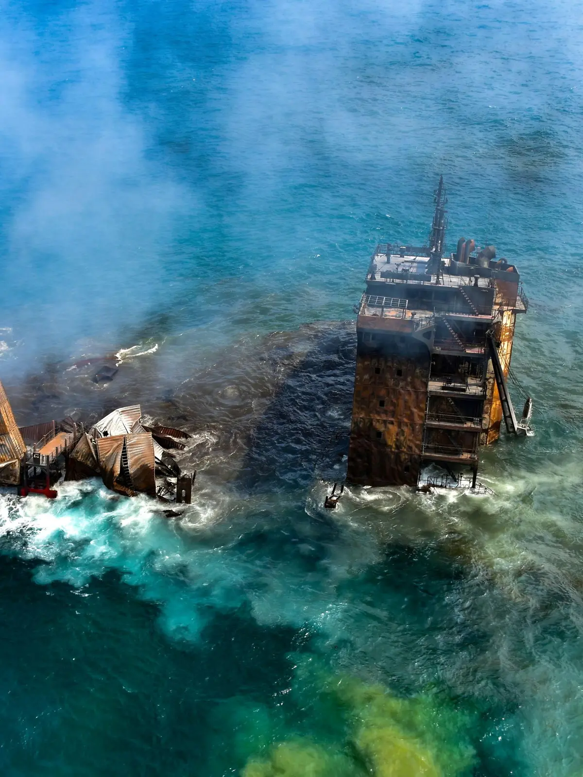 Smoke rises from a fire onboard the MV X-Press Pearl vessel as it sinks while being towed into deep sea off the Colombo Harbour, in Sri Lanka June 2, 2021. Sri Lanka Airforce Media/Handout via REUTERS ATTENTION EDITORS - THIS IMAGE HAS BEEN SUPPLIED BY A THIRD PARTY. MANDATORY CREDIT. NO RESALES. NO ARCHIVES.     TPX IMAGES OF THE DAY
